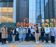 Group of people standing in front of the Alibaba campus.