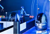 Robotic arm and a futuristic robot in a blue-lit lab