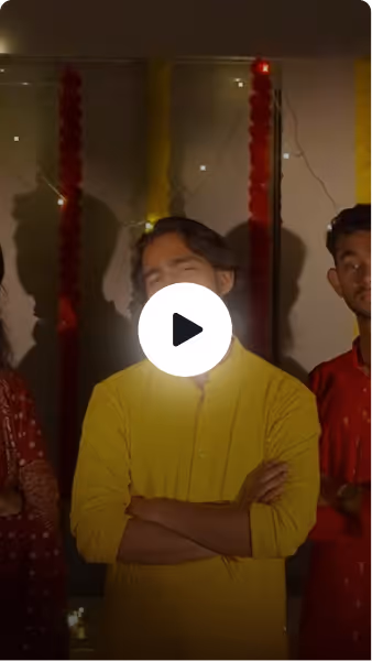Diwali & Garba Night, Rishihood University — Three young men standing with arms crossed, dressed in traditional clothes with festive decorations.