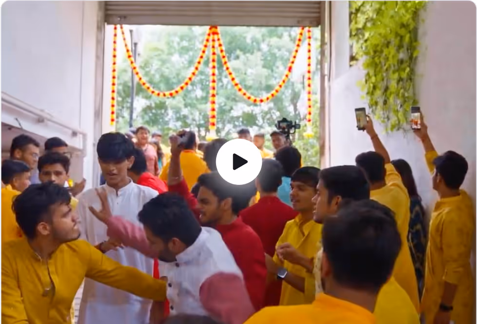 Diwali & Garba Night, ADY Patil University — Group of people in colourful traditional attire near a doorway decorated with marigold garlands.