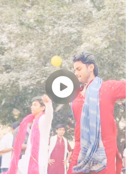 Makar Sankranti, ADY Patil University — Two young men in traditional attire dancing outdoors with trees in the background.