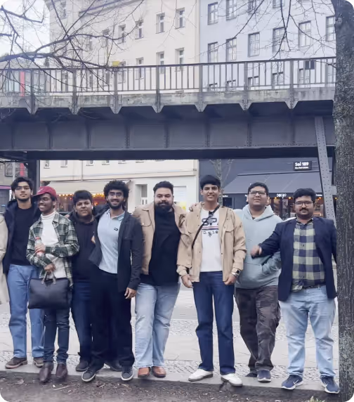 Group of eight men standing under a bridge on a city street