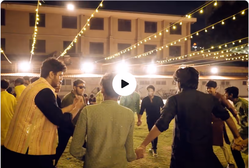 Diwali & Garba Night, ADY Patil University — Group of people holding hands and dancing outdoors at night under string lights.